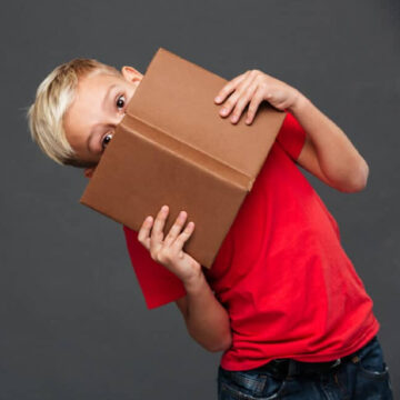 A young boy holding a book.
