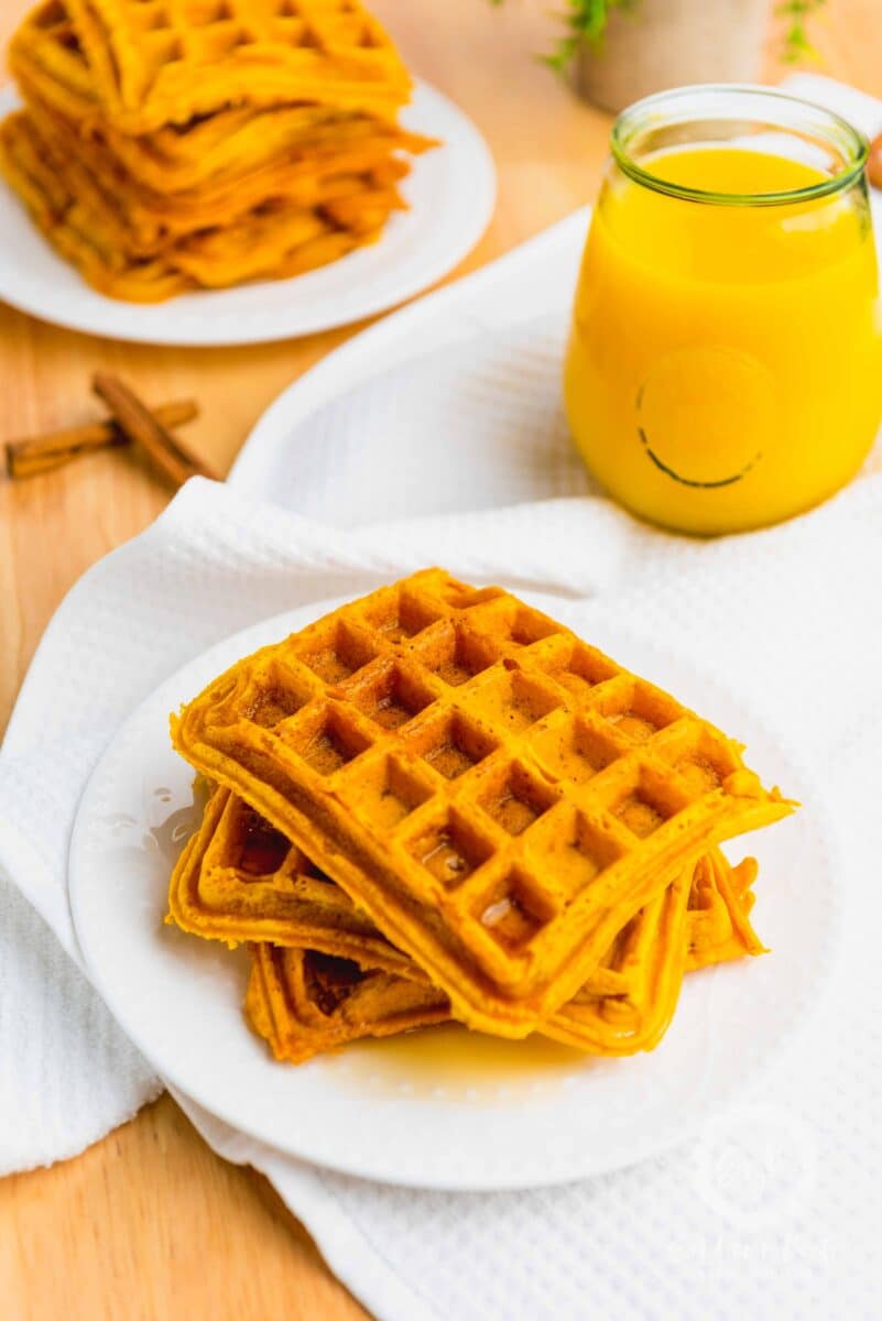 Vegan Waffles stacked on a white plate. 