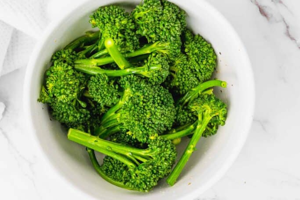 Chopped Broccolini in a white bowl. 
