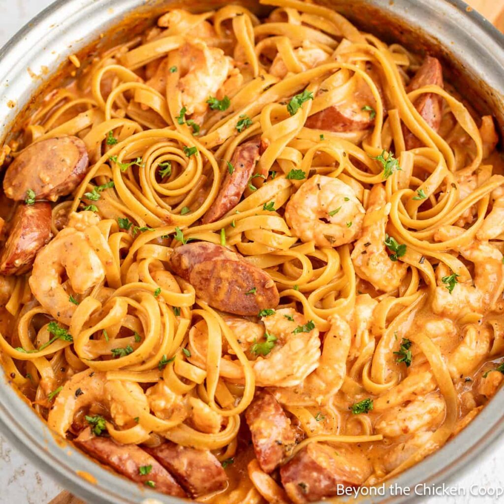 Shrimp sausage and pasta in a pot.