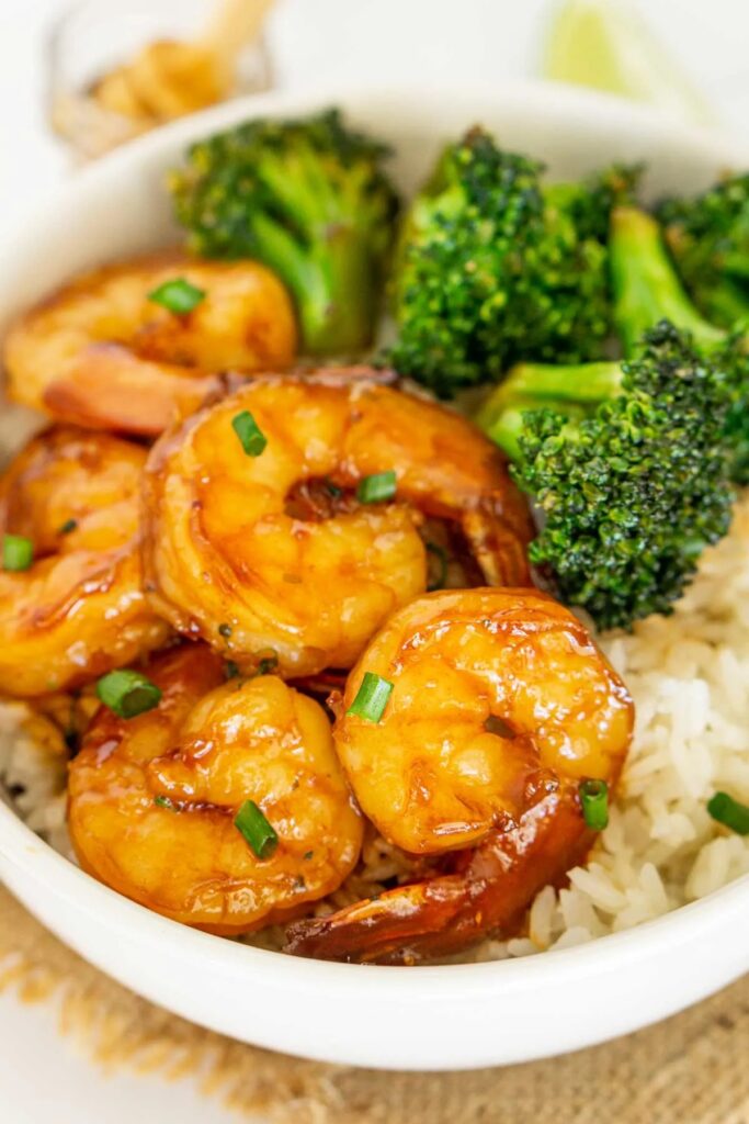 Hot honey shrimp served with broccoli and rice.