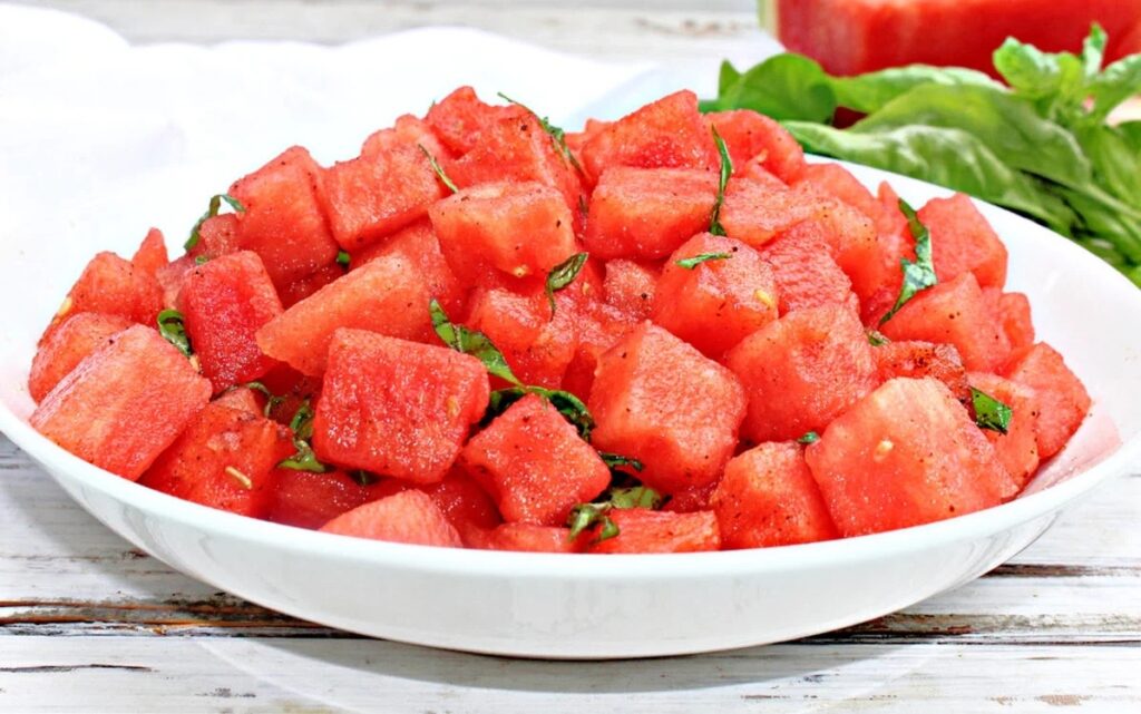 Basil watermelon salad on a plate.