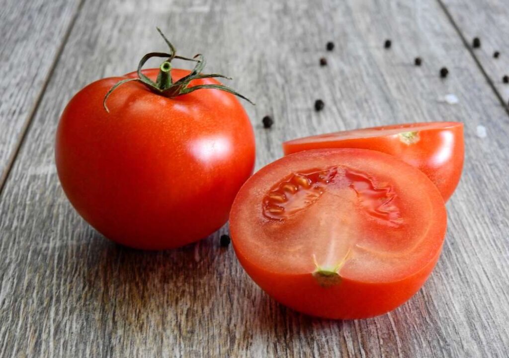 Fresh tomatoes on wooden surface