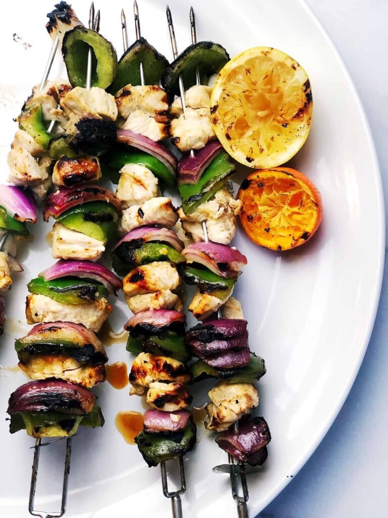 Italian chicken skewers on a plate.