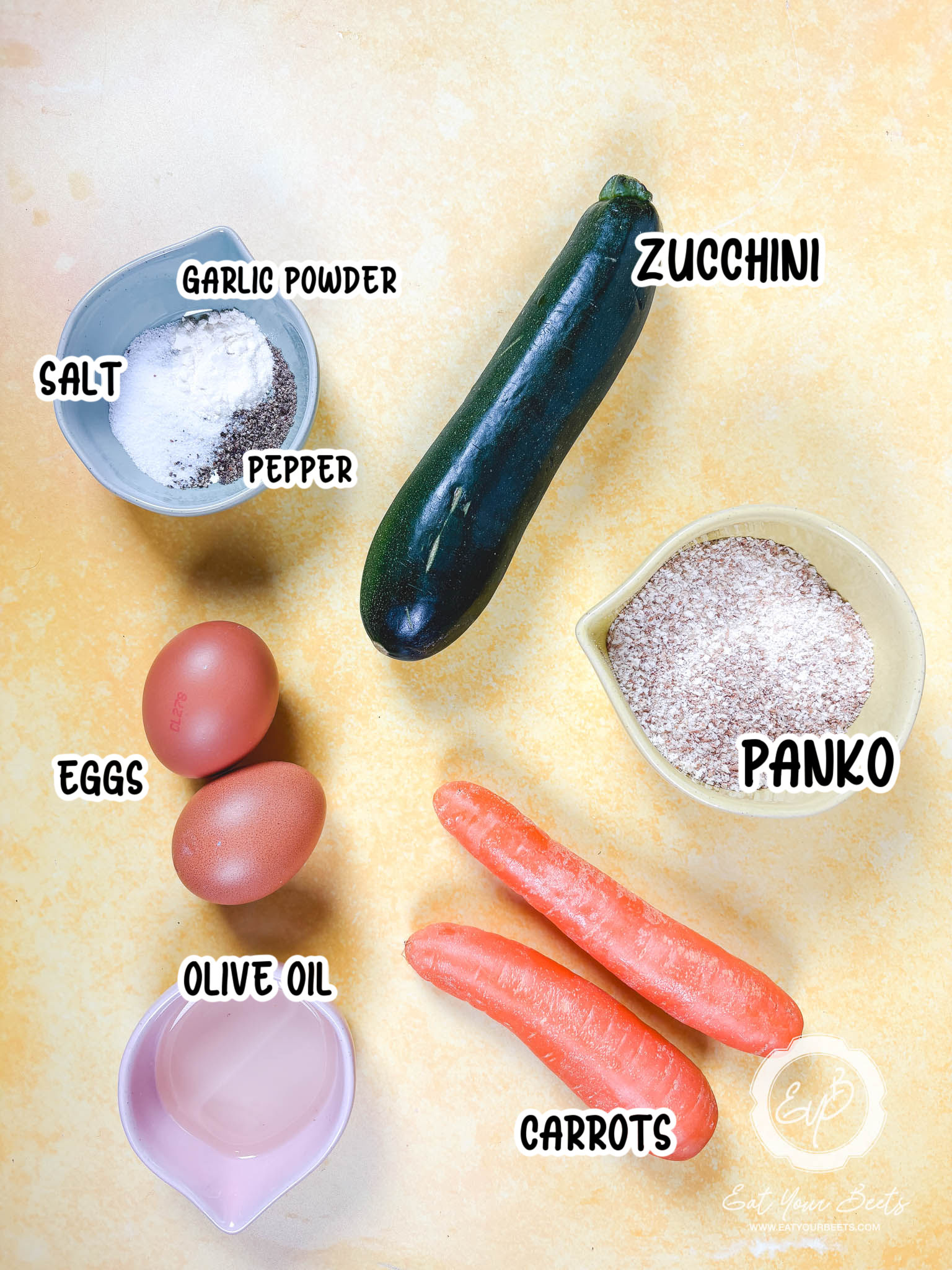 Zucchini Fritter Ingredients, Salt, Pepper, Garlic Powder, Carrrots, Zucchini, eggs and Panko Bread Crumbs.