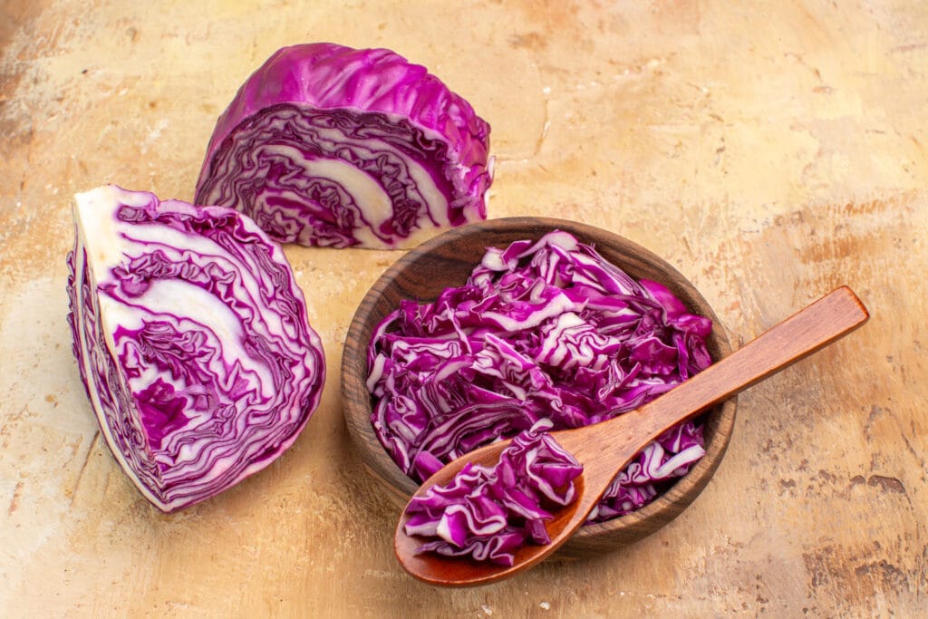 red cabbage in a bowl with wooden spoon.