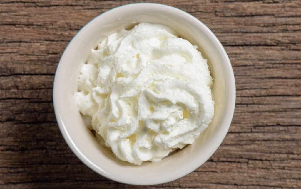 Whipped heavy cream in a bowl.