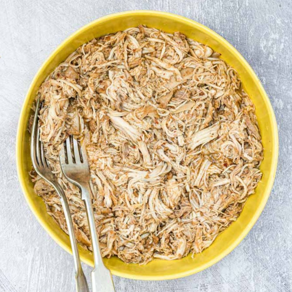 Easy Instant Pot Shredded Chicken in a yellow bowl.