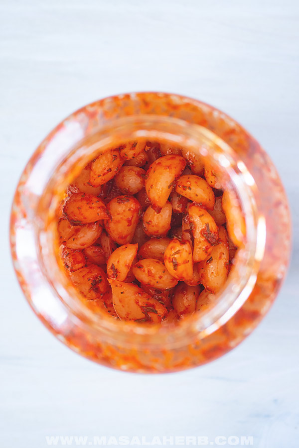 Pickled garlic in a jar.