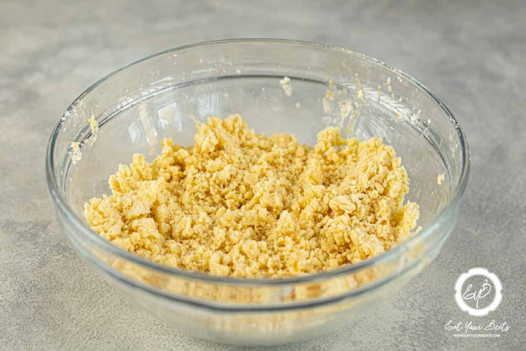 Flour mixed with yogurt and butter in a bowl.
