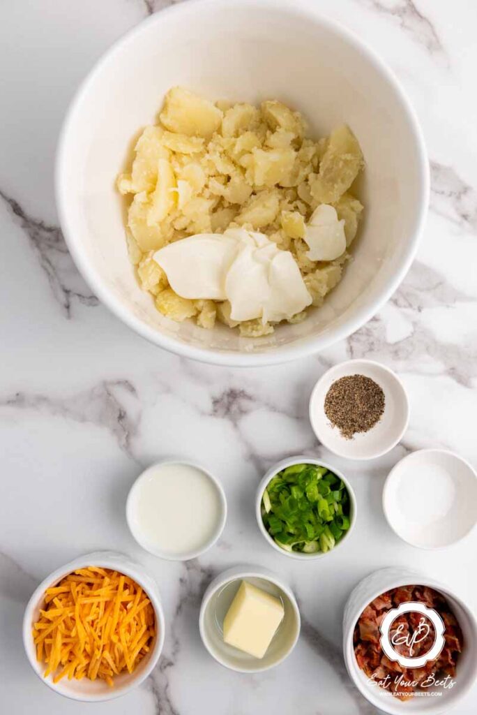 mixing potatoes with sour cream, cheese, bacon, and seasonings.