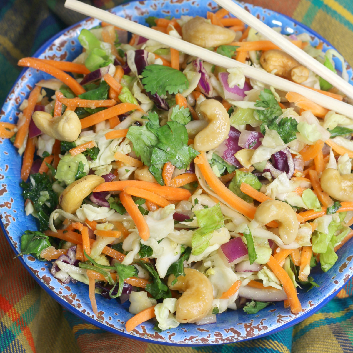 Thai Salad in a blue bowl with chopsticks.
