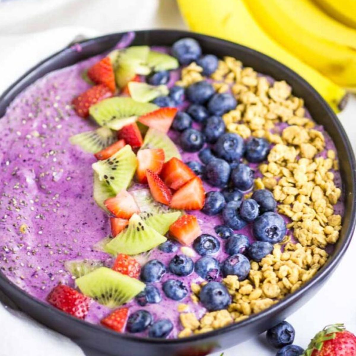 Best Blueberry Smoothie Bowl topped with fruit.
