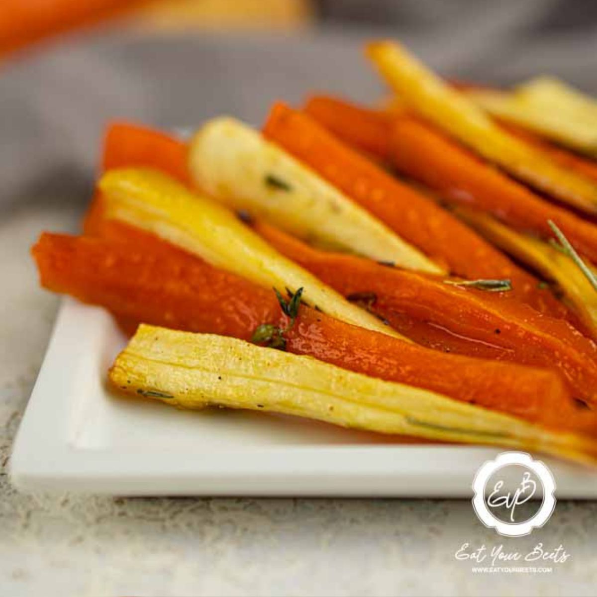 Honey Roasted Parsnips and Carrots on a white plate.