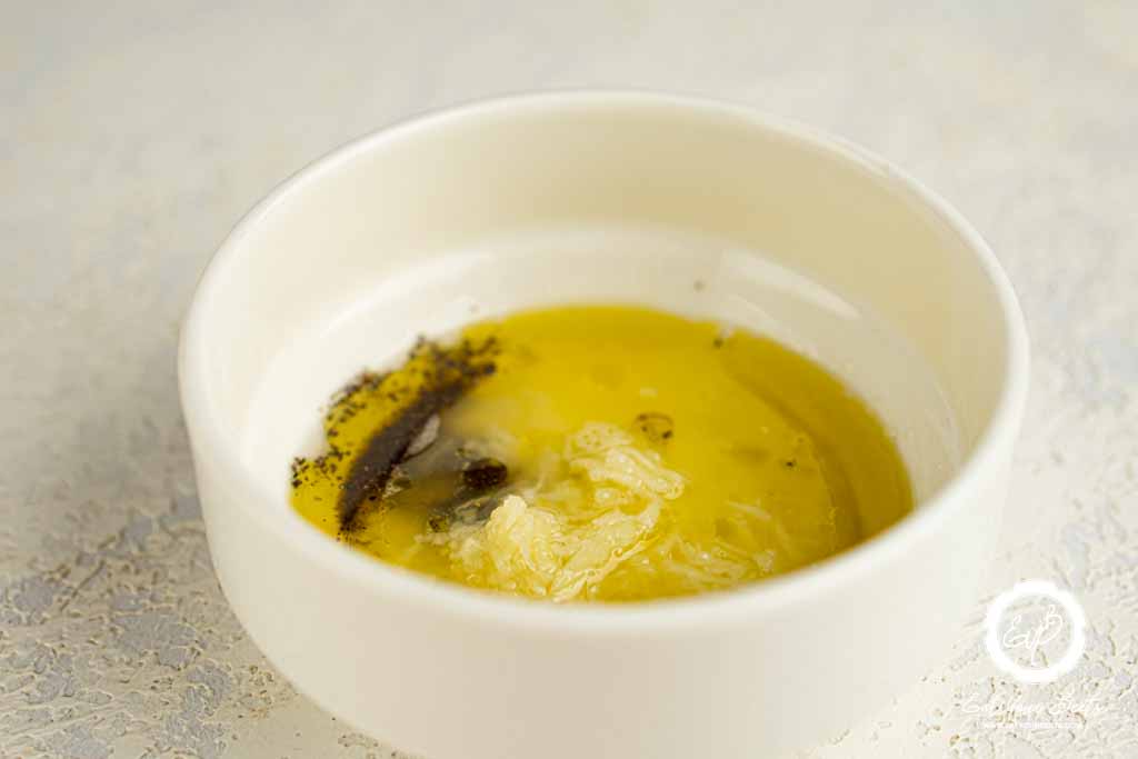 Oil, salt, pepper, lemon juice, and garlic into small bow.