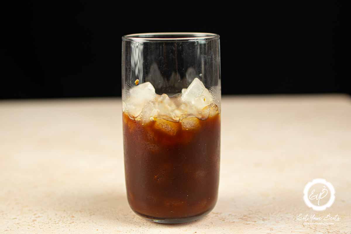 Brewed coffee and ice in a glass.