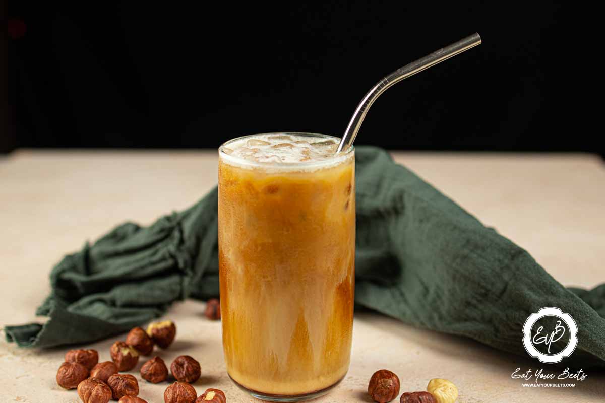 Oat milk hazelnut espresso in a glass.