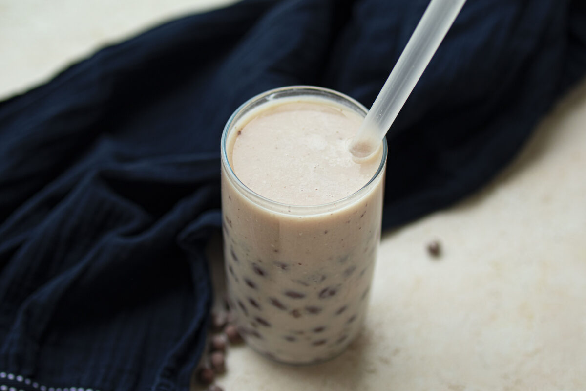 Coconut boba tea tapioca pearls in a glass.