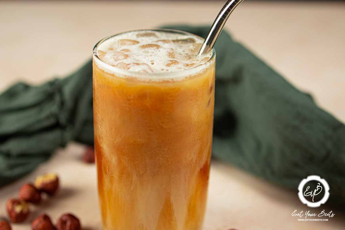 Oat milk shaken espresso in a glass.