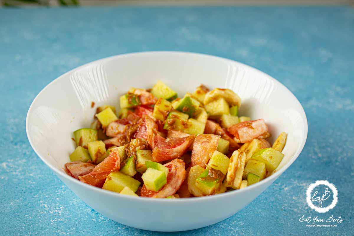 Chopped grapefruit, apple, and banana seasoned with peanut butter.