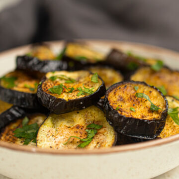 Air Fryer egg plant, seasoned with salt and pepper in a bowl.