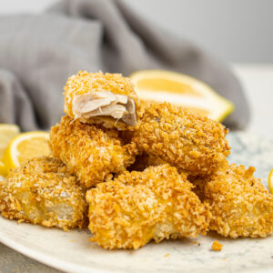 Air Fryer Fish Nuggets with lemon wedges.