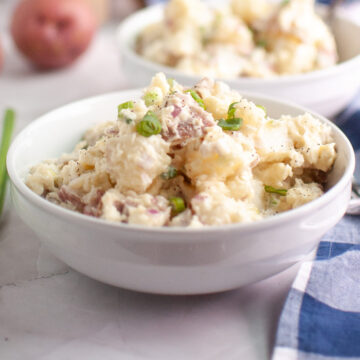 Creamy Red Potato Salad in a white serving bowl.