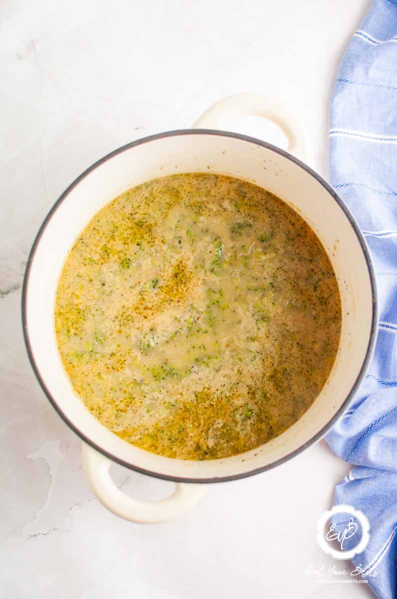 Cooked creamy broccoli blended in a pot.