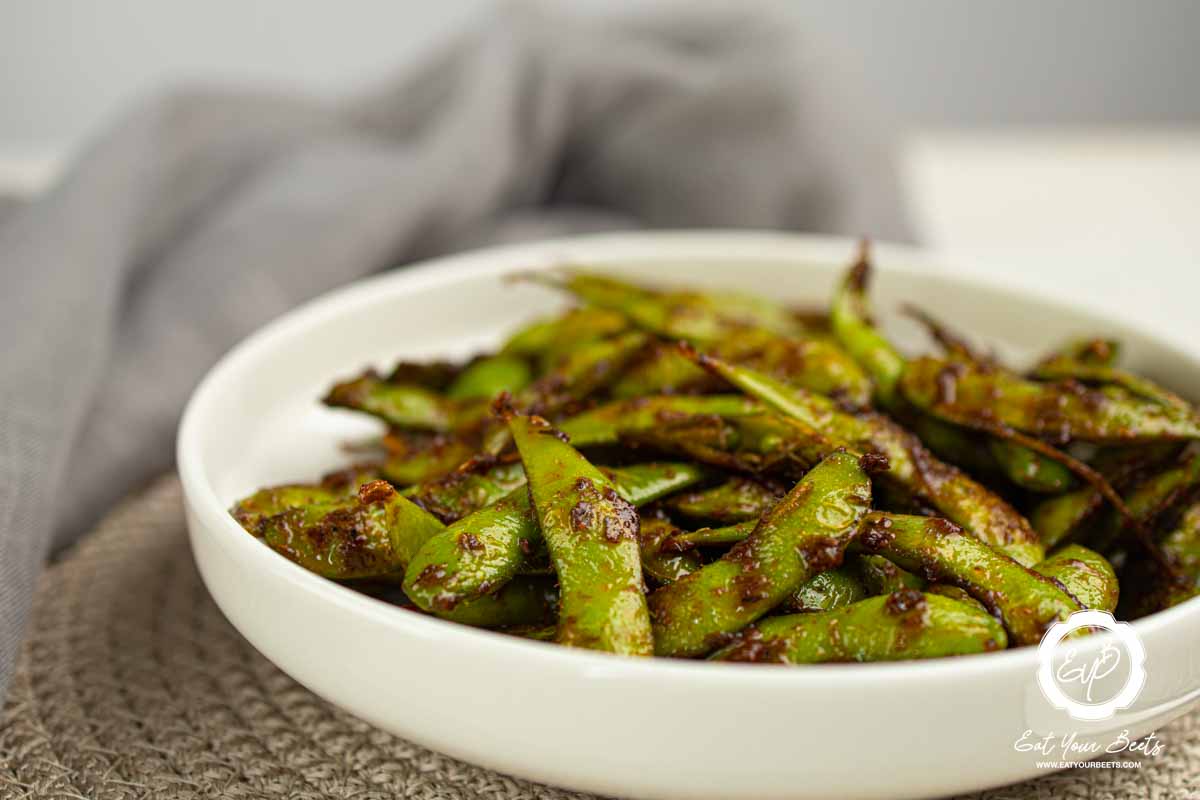 Stir fry edamame in a bowl.