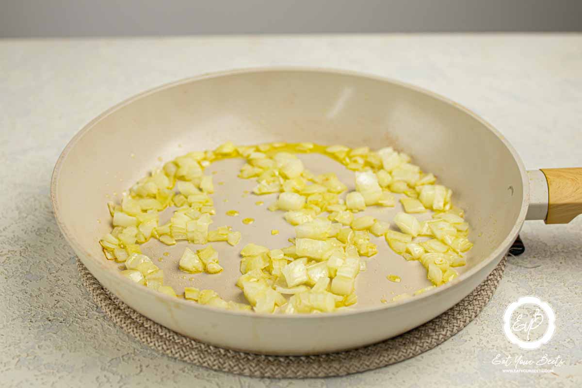 Sauteing onion in a pan.