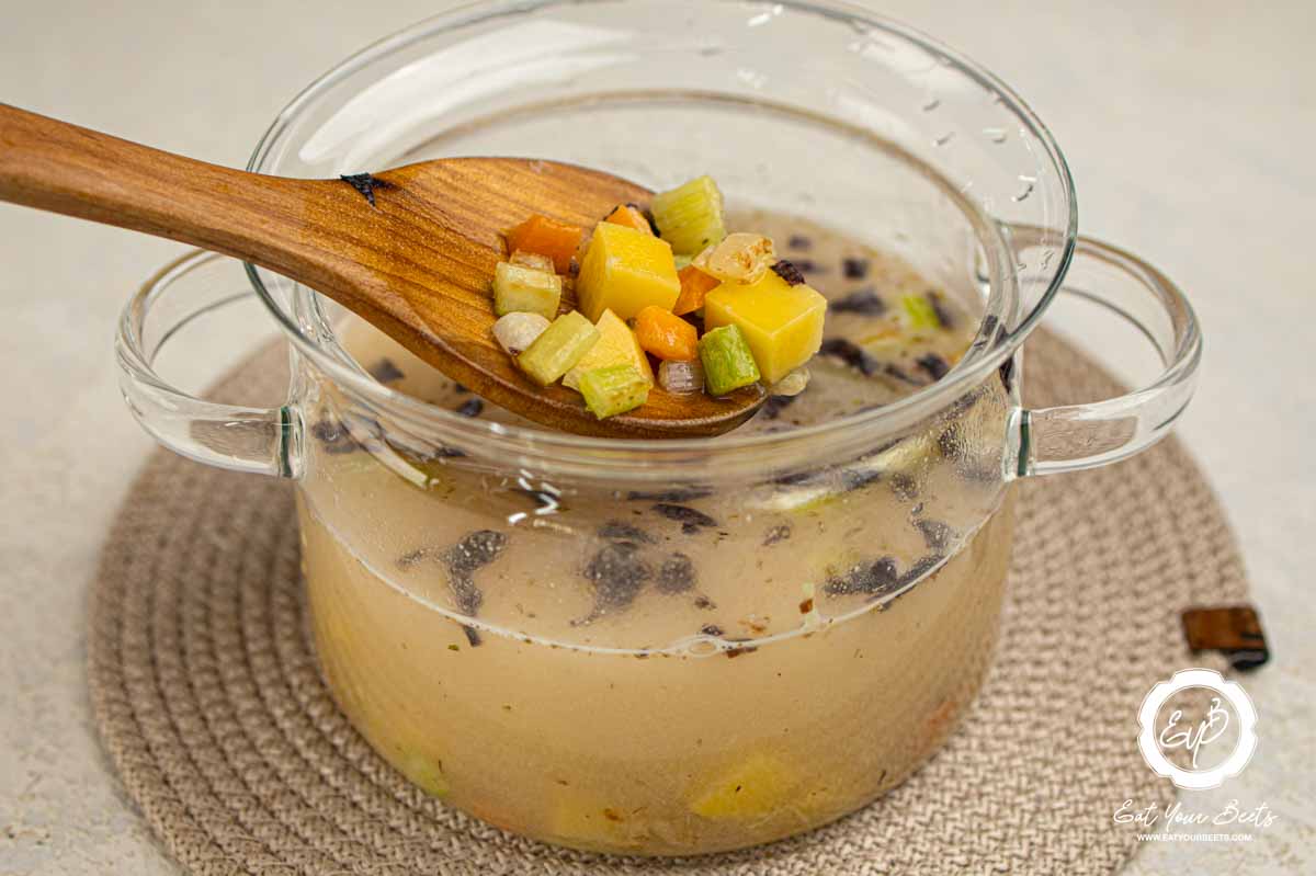 Cooked veggies in broth.