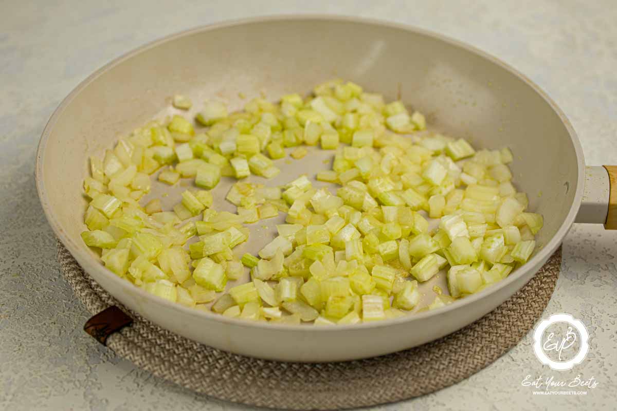 Sauteing chopped onion in a pan.
