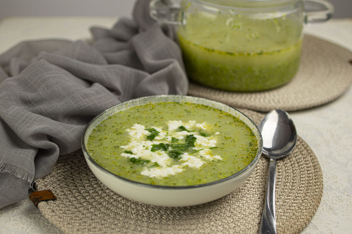 Broccoli soup with feta cheese in a bowl.