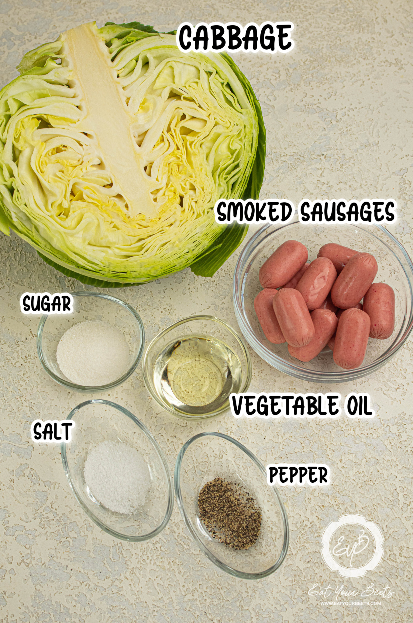 Ingredients for cajun smothered cabbage, smoked sausages, cabbage.