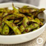 edamame stir fry in a white bowl.