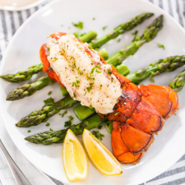 Oven baked lobster tail with garlic butter and lemon.