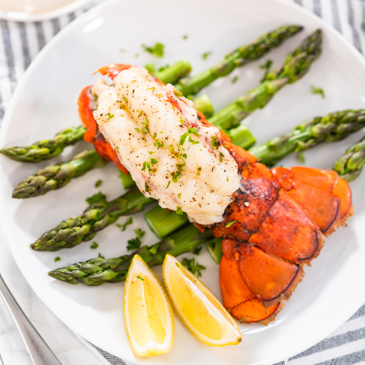 Oven baked lobster tail with garlic butter and lemon.