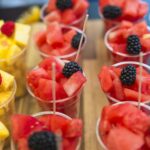 close-up-watermelon-slices-with-blackberry-plastic-disposable-cup-perfect for a summer party.