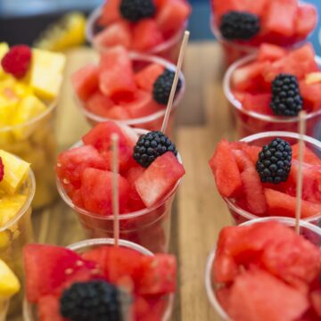 close-up-watermelon-slices-with-blackberry-plastic-disposable-cup-perfect for a summer party.